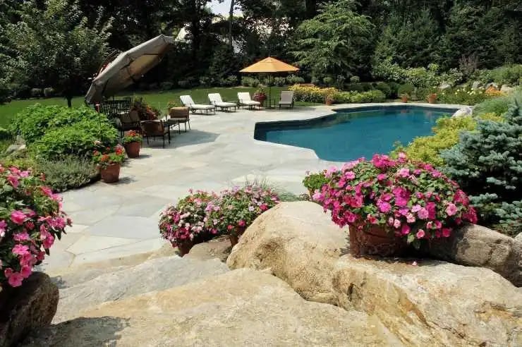 natural stones beside home pool adding beauty