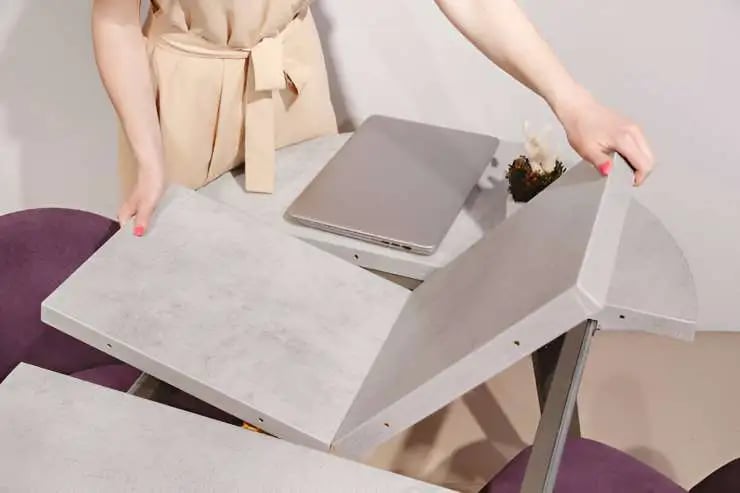 Woman setting up extendable table